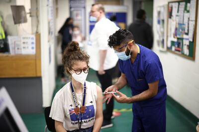 A person receives a dose of the Pfizer BioNTech vaccine at a vaccination centre for those aged over 18 years old at the Belmont Health Centre in Harrow, amid the coronavirus disease (COVID-19) outbreak in London, Britain, June 6, 2021. REUTERS/Henry Nicholls