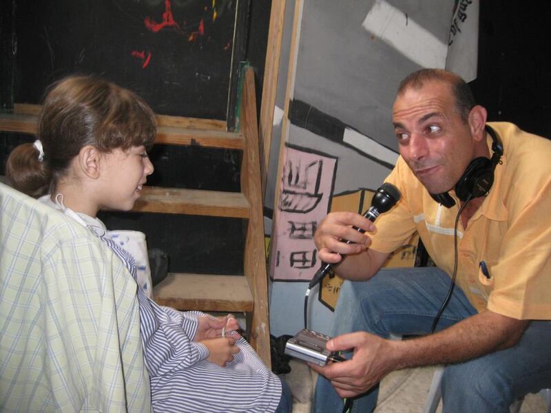 Hossam Madhoun at a drama-therapy programme for children in Gaza. Courtesy Hossam Al Madhoun