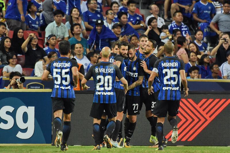 Inter Milan players celebrate with Stevan Jovetic after his opening goal against Chelsea. Roslan Rahman / AFP