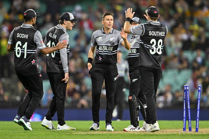 Trent Boult celebrates with teammates after bowling Australia's Mitchell Starc. AFP