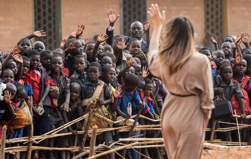 US First Lady Melania Trump waves to children at the Chipala Primary School in Lilongwe in Malawi. Saul Loeb / AFP