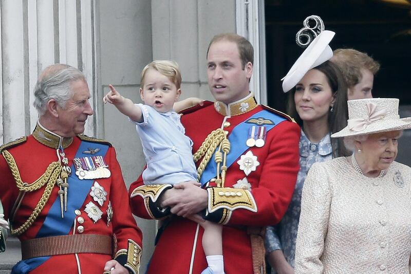 Britain’s Prince William holds his son Prince George, with Queen Elizabeth II, right, Kate, Duchess of Cambridge and the Prince of Wales during the Trooping The Colour parade at Buckingham Palace, in London. Tim Ireland / AP photo