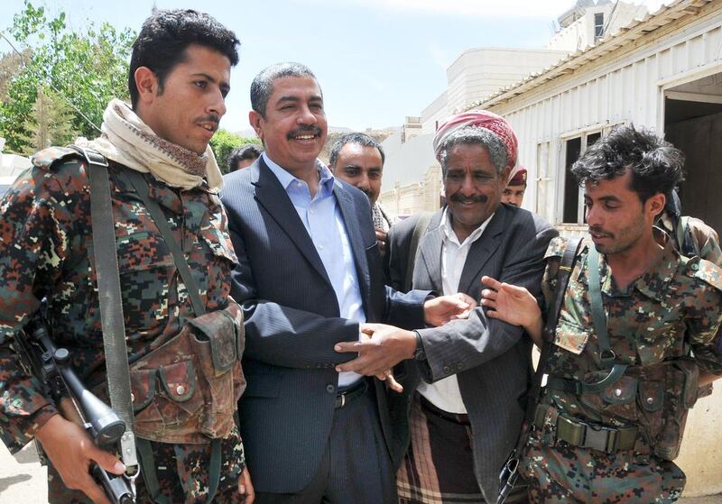 Yemeni prime minister Khaled Bahah (second from left) is greeted by supporters outside his house in Sanaa on March 16, 2015 after the Houthis agreed to free him and all his cabinet ministers after nearly two months of house arrest. STR/AFP Photo


