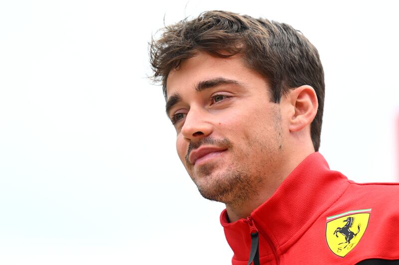 Ferrari's Charles Leclerc walks in the paddock. Getty