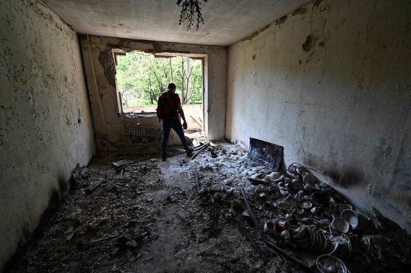 Evgeny, 31, stands in his damaged apartment in the Saltivka district, northern Kharkiv. AFP
