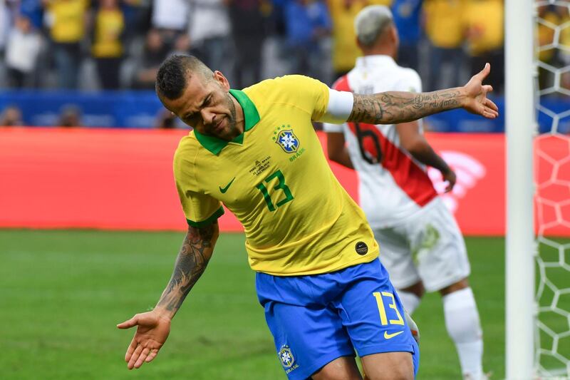 Brazil's Dani Alves celebrates after scoring against Peru. AFP