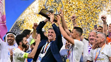Ain's Argentine coach Hernan Crespo raises the winner's trophy after the second leg of the AFC Champions League Final between UAE's Al Ain and Japan's Yokohama F.  Marinos at the Hazza Bin Zayed Stadium in Al-Ain on May 25, 2024.  (Photo by Giuseppe CACACE  /  AFP)