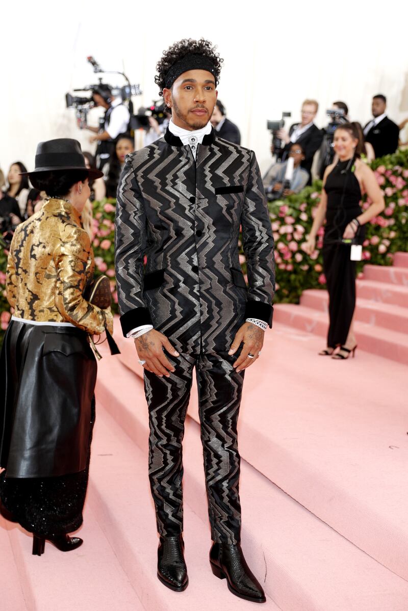Lewis Hamilton, in a metallic Tommy Hilfiger suit, arrives on the red carpet for the 2019 Met Gala at the Metropolitan Museum of Art on May 6, 2019. EPA