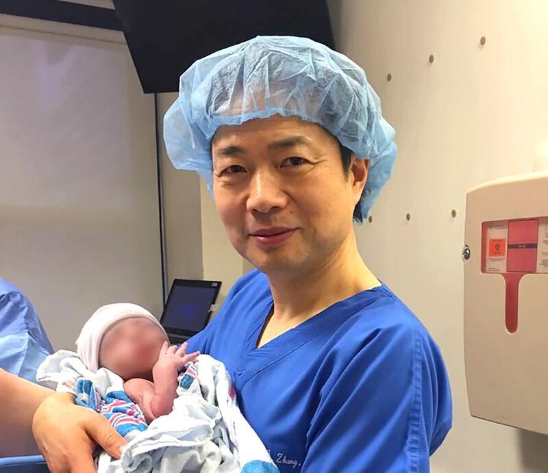 Dr John Zhang with the world’s first baby born using DNA from three people. Courtesy New Hope Fertility Centre