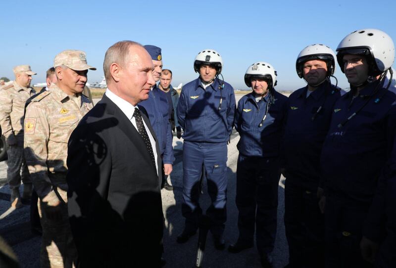 epaselect epa06382902 Russian President Vladimir Putin (L) meets with Russian servicemen at the Hmeimim (also Khmeimim) Air Base, south-east of the city of Latakia in Syria, 11 December 2017. Media reports state Russian President Vladimir Putin made an unannounced visit to Syria where he met with Syrian Presidents Bashar al-Assad and ordered a withdrawal of Russian troops from Syria.  EPA/MICHAEL KLIMENTYEV / SPUTNIK / KREMLIN / POOL MANDATORY CREDIT