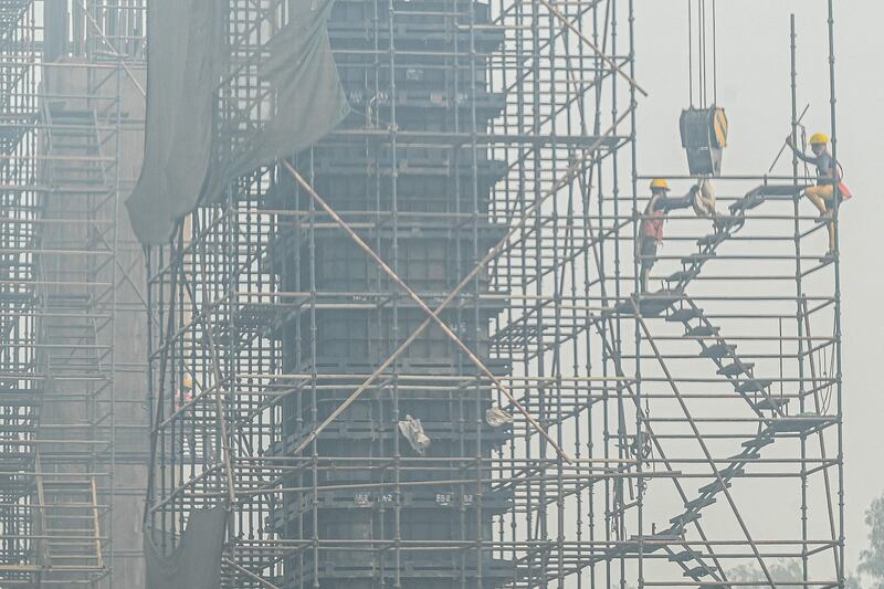 Labourers work at the construction site of the Delhi–Meerut Regional Rapid Transit System in smoggy conditions in Ghaziabad. AFP