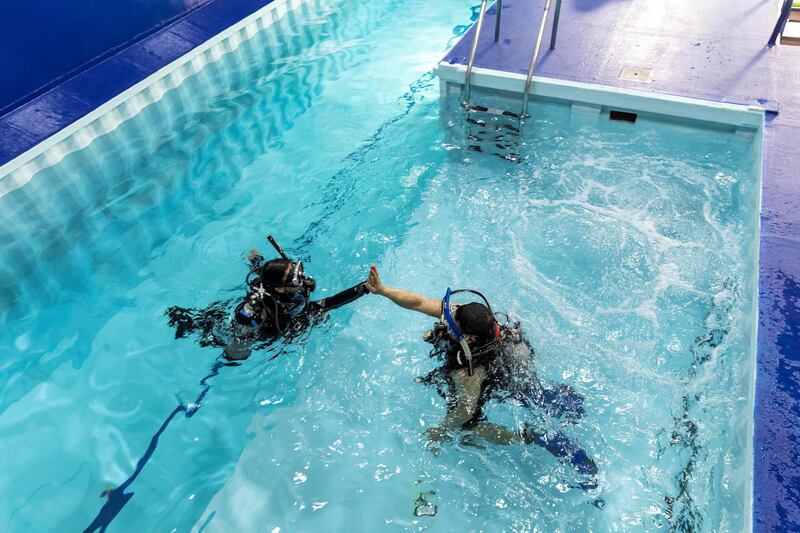DUBAI, UNITED ARAB EMIRATES. 07 MARCH 2021. Michela Colella, Dive Instructor, conducts a training session with a learner diver in the newly opened indoor pool at the Dive Garage facility in Al Quoz 4. The pool is constructed out of shipping containers and hols a 100 000 liters of fresh water, making it one of a kind in the Middle East. (Photo: Antonie Robertson/The National) Journalist: Janice Rodriques. Section: National.