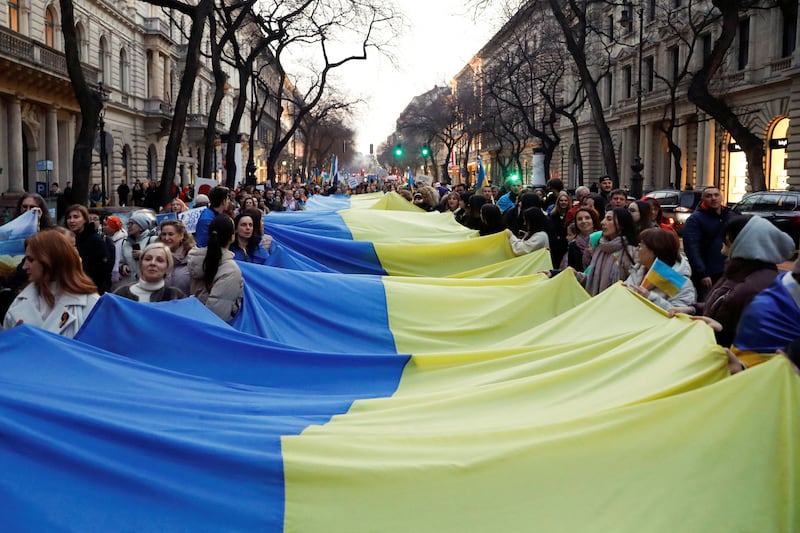 Supporters hold a Ukrainian flag at a solidarity march to mark the first anniversary of the Russian invasion of Ukraine, in Budapest, Hungary. Reuters