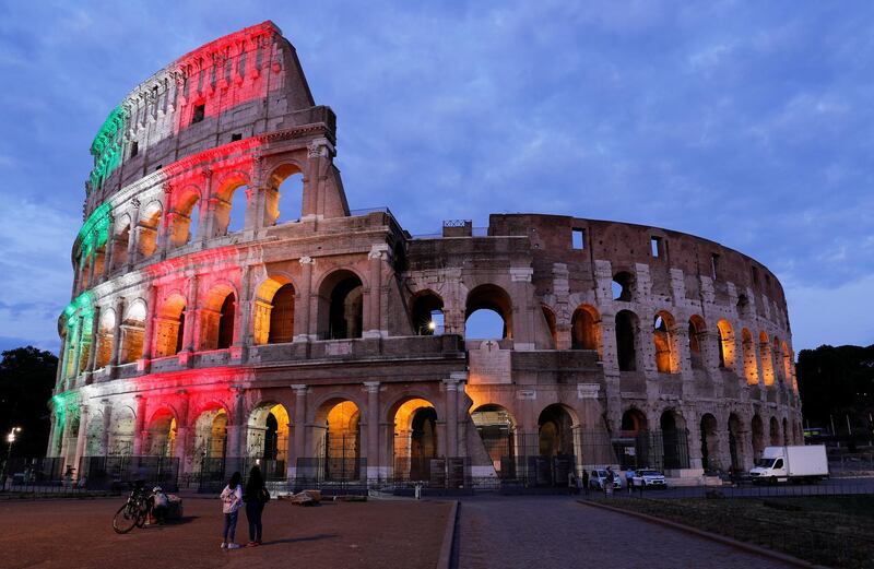 Rome's ancient Colosseum is lit with colours of the Italian flag to show unity, solidarity and to honour victims of the coronavirus disease (COVID-19) from all over the world, in Rome, Italy, May 31, 2020. REUTERS/Remo Casilli