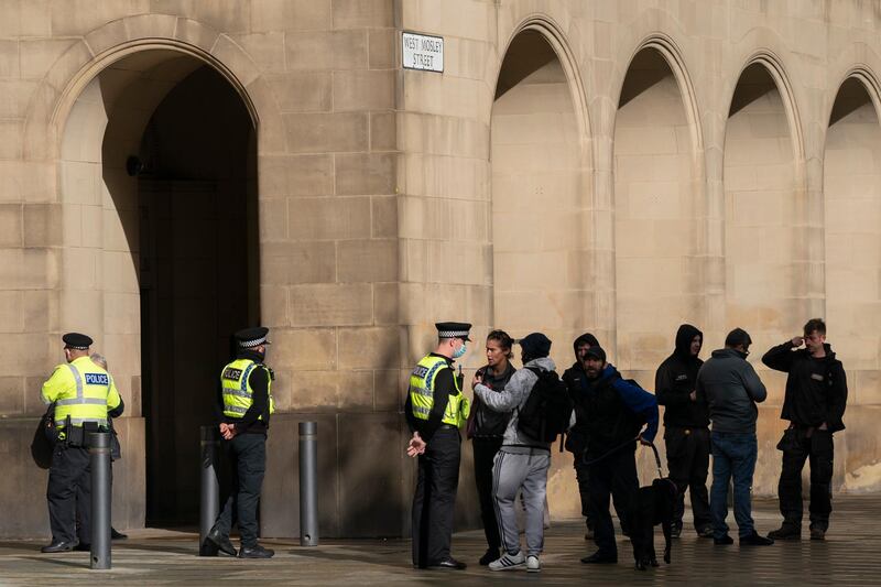 Police officers talk to people in Manchester city centre. AP Photo