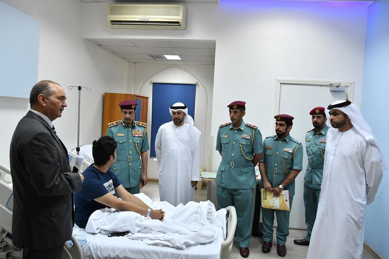 Ajman officials, including members of the police, visited patients who fell ill after the water supply was contaminated by a sewage pipe leak at an apartment complex. Courtesy Ajman Police