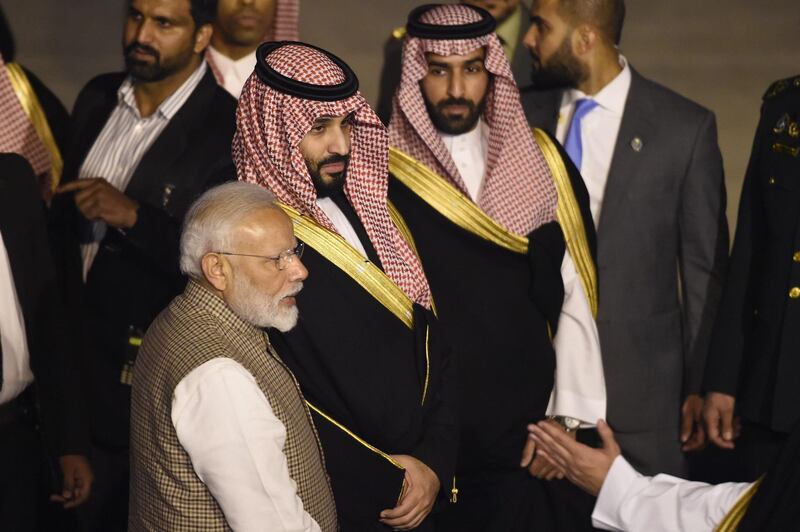 Saudi Crown Prince Mohammed Bin Salman stands next to Indian Prime Minister Narendra Modi upon arriving at the airport in New Delhi. AFP