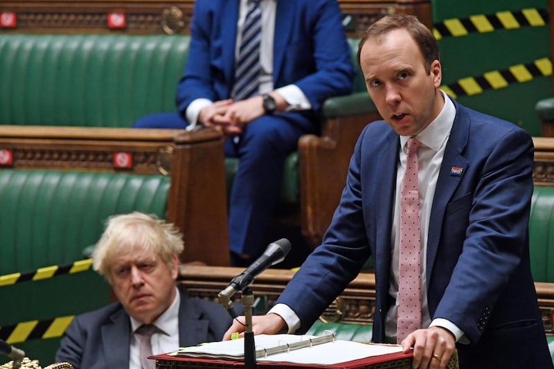 (FILES) In this file handout photo taken and released by the UK Parliament taken on November 26, 2020, Britain's Prime Minister Boris Johnson (L) listens as Britain's Health Secretary Matt Hancock gives a COVID-19 update statement to a hybrid, socially distanced session in the House of Commons in London. British Prime Minister Boris Johnson in private WhatsApp exchanges slammed the health minister's "hopeless" handling of the pandemic, his former top aide claimed on June 16, 2021. Dominic Cummings, who stepped down as Johnson's top adviser in December, posted screenshots of WhatsApp exchanges apparently between him and the prime minister in March and April 2020 as the UK battled the first wave of the pandemic. / AFP / UK PARLIAMENT / JESSICA TAYLOR
