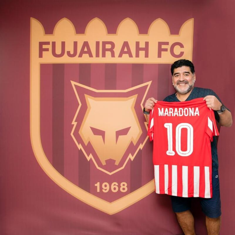 Diego Maradona poses alongside the Fujairah logo following his appointment as manager in May. Courtesy Fujairah Football Club