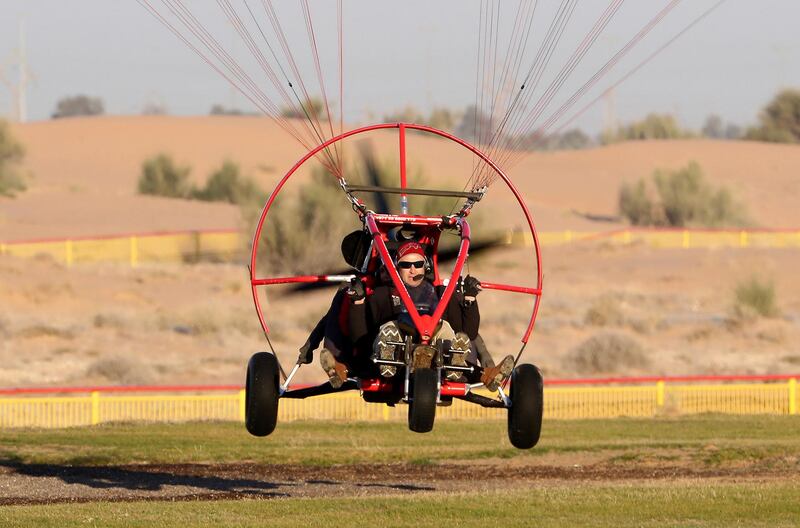 DUBAI, UNITED ARAB EMIRATES , January 13 – 2021 :- Pilot Alexandr Ctitor flying after the sunrise at the Paramotor Desert Adventure Aviation Club on Dubai- Al Ain road in Dubai. (Pawan Singh / The National) For News/Online. Story by Sarwat