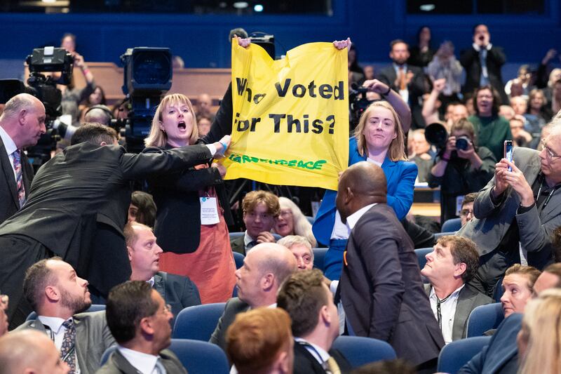Greenpeace protesters interrupt Prime Minister Liz Truss as she delivers her keynote speech. PA
