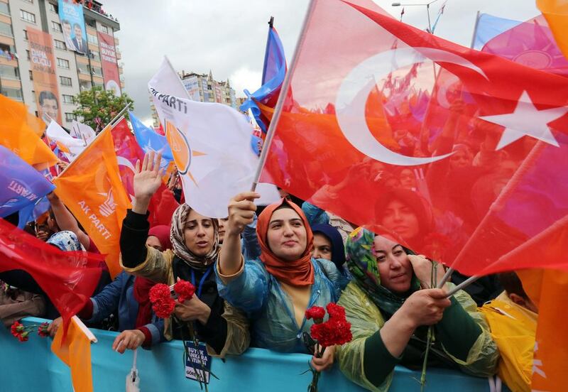 Supporters cheer Turkish prime minister Ahmet Davutoglu (not in the picture) as he addresses an election rally in Ankara. Burhan Ozbilici / AP Photo