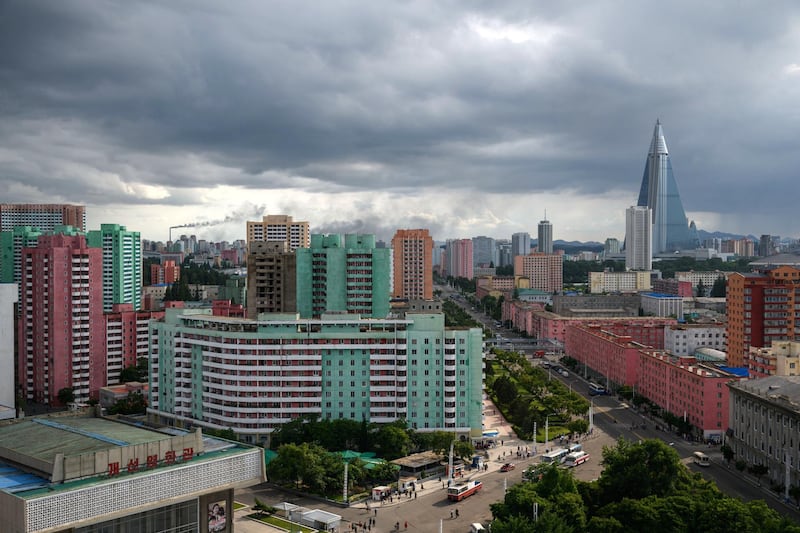 A photo taken on June 15, 2018 shows the Ryugyong Hotel in the distance of this general view of the Pyongyang's skyline. 
Donald Trump dangled the carrot of foreign investment in front of North Korean leader Kim Jong Un at their nuclear summit, but analysts say few will want to put money into one of the highest-risk business environments in the world. / AFP PHOTO / Ed JONES / TO GO WITH AFP STORY: NKorea-Economy-Diplomacy-Nuclear; Focus by Sebastien BERGER