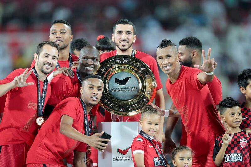 Al Ahli players celebrate with the Arabian Gulf League trophy after their final match of the season. Christopher Pike / The National