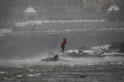 US Coast Guard Petty Officer 2nd Class Derrian Duryea retrieves the body of a woman from a partially submerged car at Niagara Falls. AP