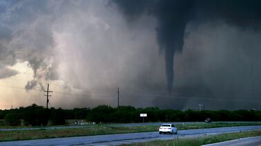 A tornado spins to the west of the city of Hawley, Texas, about 23km north of Abilene, as cars pass on an almost deserted US Route 277 on Thursday May 2, 2024. AP