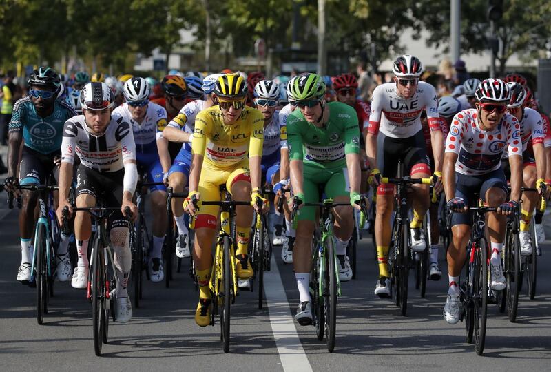 UAE Team Emirates rider Tadej Pogacar of Slovenia, is seen wearing the overall leader's yellow jersey, and Deceuninck-Quick Step rider Sam Bennett of Ireland, wearing the green jersey, before the official start. REUTERS