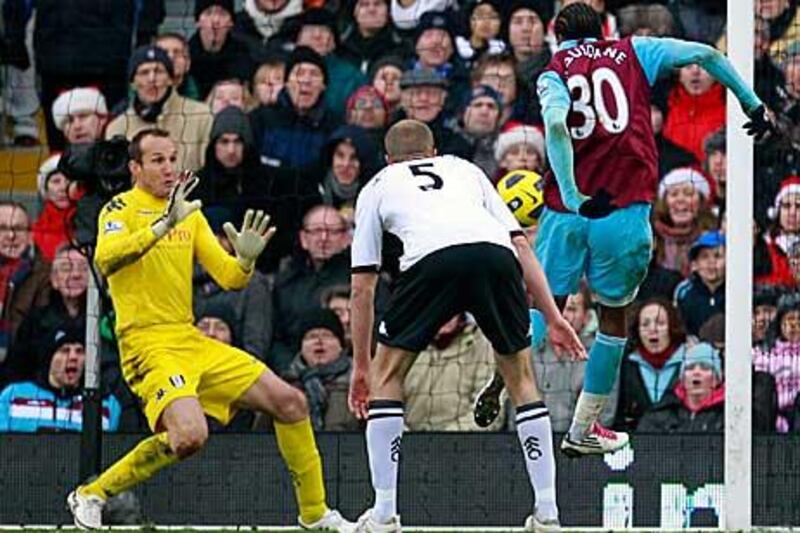 West Ham's Frederic Piquionne, right, scores past Fulham's goalkeeper Mark Schwarzer.