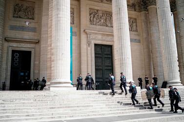 French police officers walk in Pantheon in Paris as undocumented migrants occupy the landmark to ask for the regularisation of their situation, on July 12, 2019. AFP/Kenzo TRIBOUILLARD