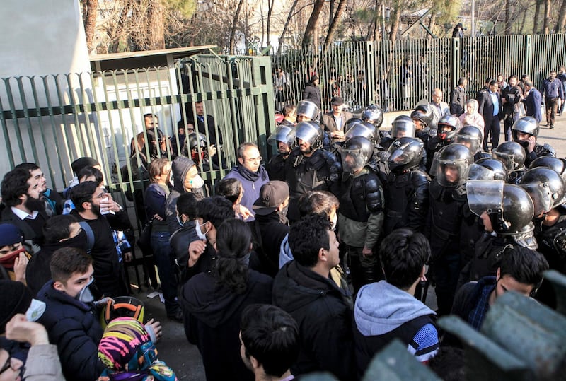 FILE- In this Dec. 30, 2017 file photo taken by an individual not employed by the Associated Press and obtained by the AP outside Iran, anti-riot Iranian police prevent university students to join other protesters over Iran weak economy, in Tehran, Iran. New unrest in Iran over the past 10 days appears to be waning, but anger over the economy persists. The protests in dozens of towns and cities also showed that a sector of the public was willing to openly call for the removal of Iranâ€™s system of rule by clerics -- frustrated not just by the economy but also by concern over Iranâ€™s foreign wars and general direction. (AP Photo, File)