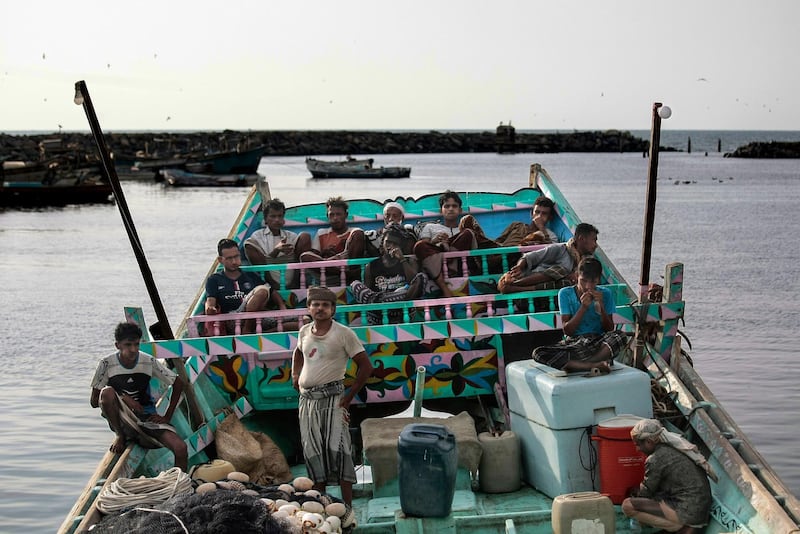 In this Sept. 29, 2018, photo, fishermen take a break and chew Qat, an amphetamine-like stimulant, on a boat at the main fishing port, in Hodeida, Yemen. (AP Photo/Hani Mohammed)