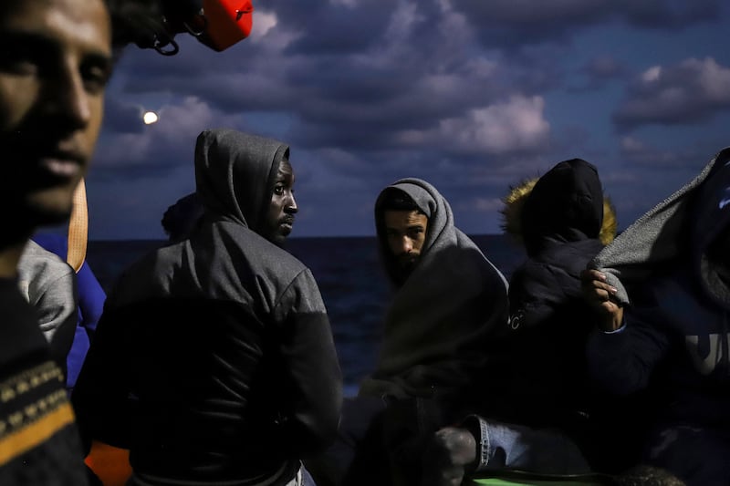 Migrants sit on the deck of the 'Sea Watch-3' rescue ship in the Mediterranean on October  19. AP