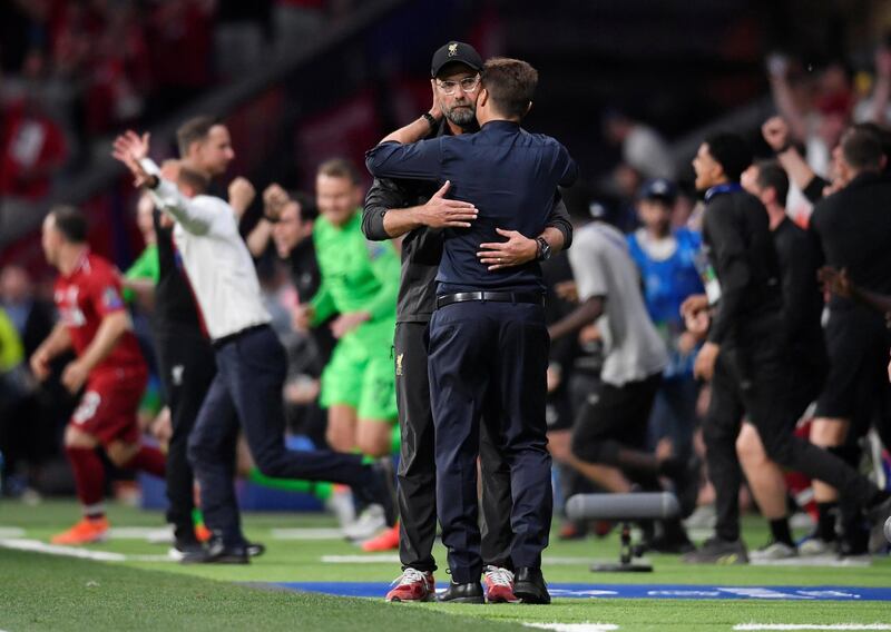 Klopp and Tottenham manager Mauricio Pochettino embrace after the match. Reuters