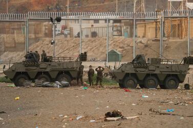 Spanish soldiers stand near the fence at the Spanish-Moroccan border at El Tarajal Beach. Reuters