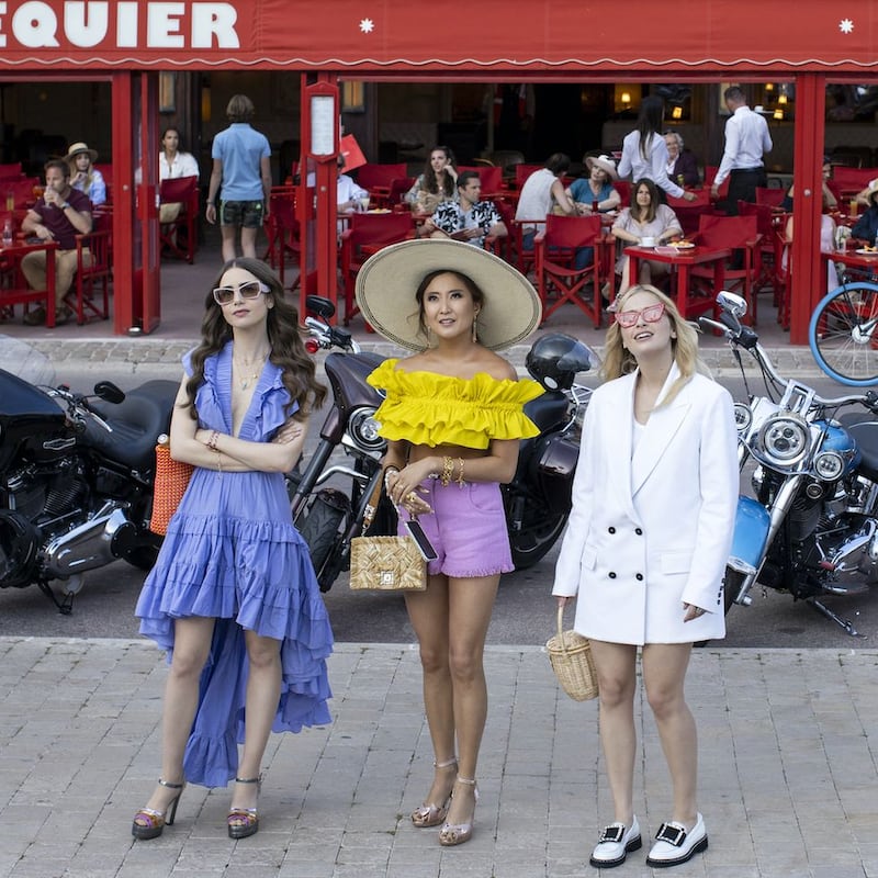 Emily wears a ruffled dress by Magali Pascal, Miu Miu sunglasses and an orange beaded Carel bag.