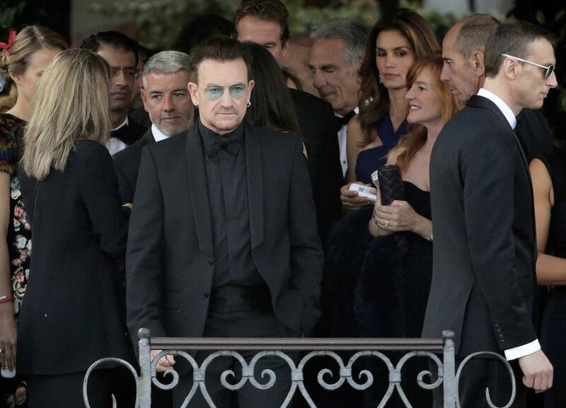 Irish singer Bono, front centre, lead vocalist of band U2, arrives to board a taxi boat transporting guests to the venue of a gala dinner ahead of the wedding of George Clooney and Amal. Reuters