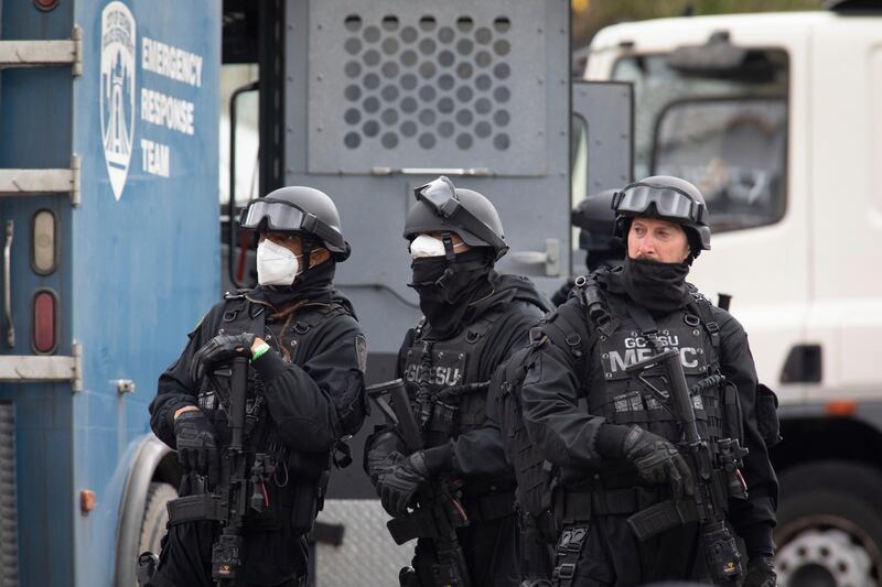 Actors and extras playing armed police officers pictured during the filming. Getty Images