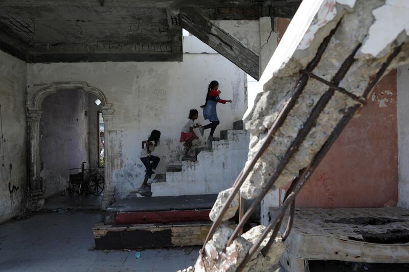 Kids play inside a house that was damaged by the 2004 Indian Ocean earthquake and tsunami, in Banda Aceh, Indonesia.  EPA