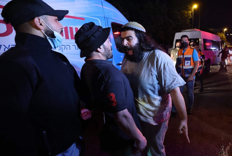 An Israeli settler confronts Palestinian protesters during a demonstration amid Israeli attempts to take control of homes in the Sheikh Jarrah neighbourhood of East Jerusalem, on May 5, 2021. AFP