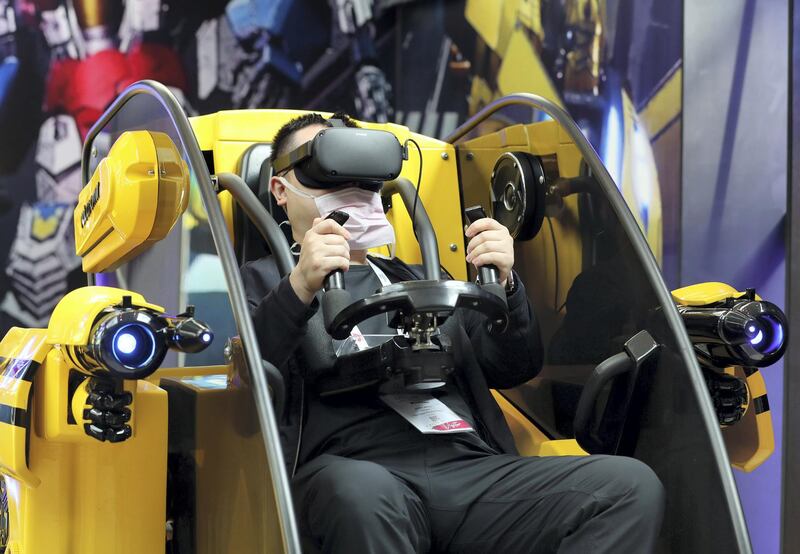 Dubai, United Arab Emirates - December 06, 2020: A visitor plays a VR transformers game during GITEX 2020 at the World Trade Centre. December 6th, 2020 in Dubai. Chris Whiteoak / The National