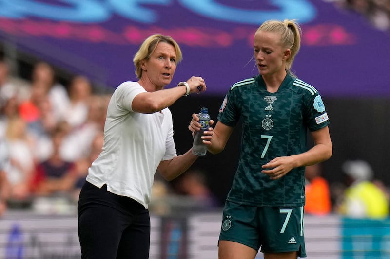 Germany manager Martina Voss-Tecklenburg talks with Lea Schueller. AP
