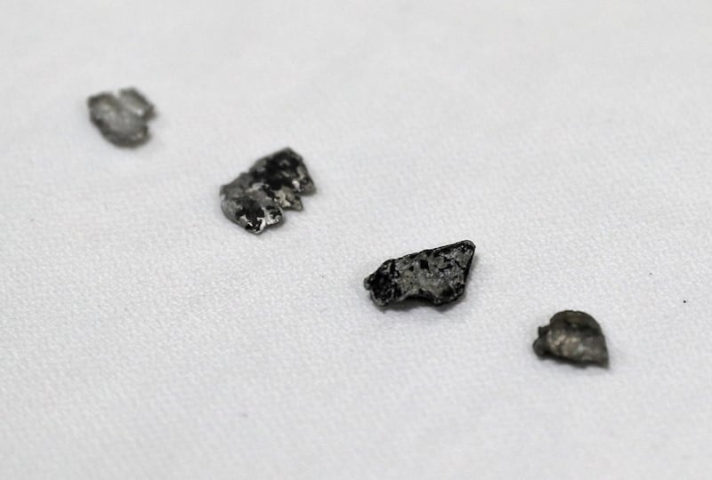 Pieces of aluminium and composite debris that the U.S. Navy says came from a limpet mine attack. AP Photo