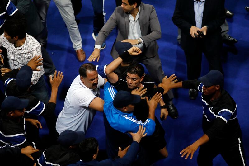 Egyptian referee Ibrahim Noor El Din, centre, is surrounded by policemen after a clash with player of Jordanian club Al Faisaly at the end of the Arab Club Championship final against Tunisian side Esperance de Tunis in Alexandria, Egypt, late on Sunday night. Esperance won 3-2. Ahmed Abd El Gawad / AFP