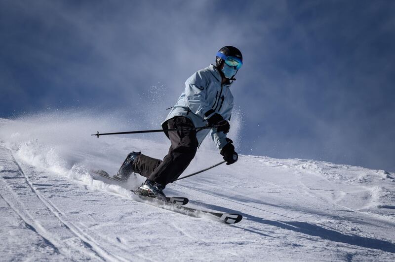 A skier wearing a protective face mask rides the slopes above the Swiss ski resort of Verbier. AFP