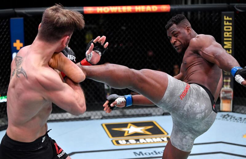 Cameroon's Francis Ngannou lands a kick on his way to victory over Stipe Miocic of the US in their UFC heavyweight championship fight at UFC 260 in Las Vegas on Saturday, March 27. USA TODAY Sports