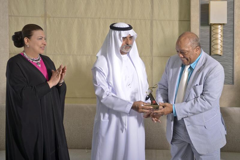 Sheikh Nahyan bin Mubarak, the Minister of Culture, Youth and Community Development, presents Quincy Jones with the Abu Dhabi Festival Award as the Admaf founder Hoda Al Khamis-Kanoo applauds. Courtesy Abu Dhabi Festival.    